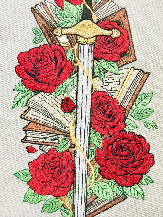 handmade embroidered sword and roses book sleeve with red floral design on linen fabric