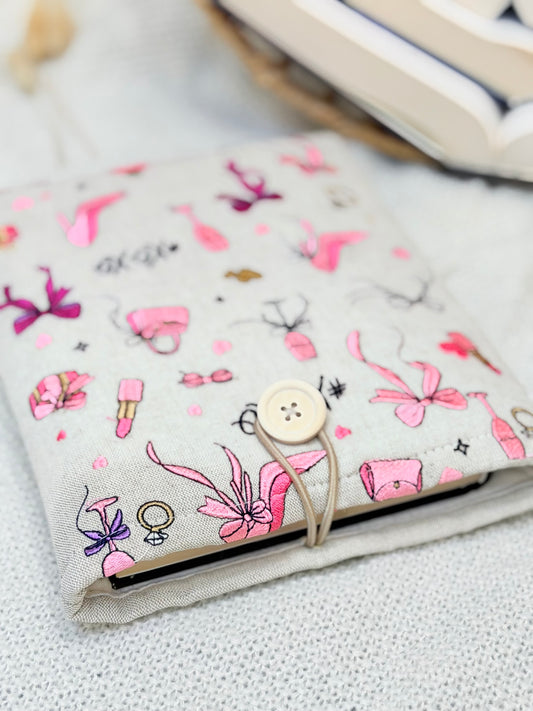 handmade embroidered pink coquette book sleeve with bows heels and lipstick design